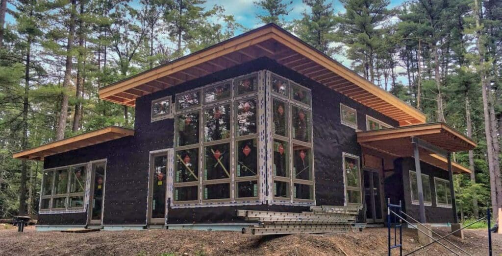 Clapper Structural Engineering black home construction to the middle of the woods.